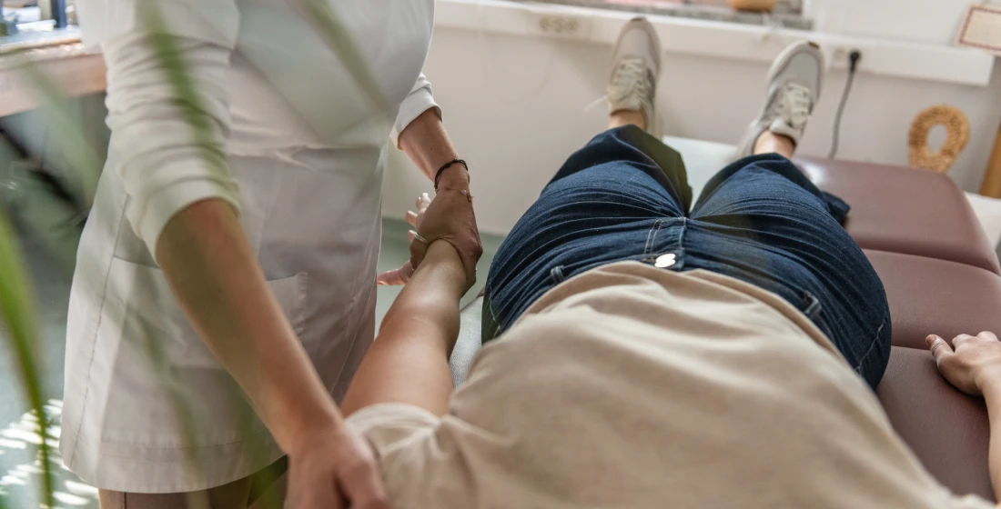 Healthcare professional performing physical therapy